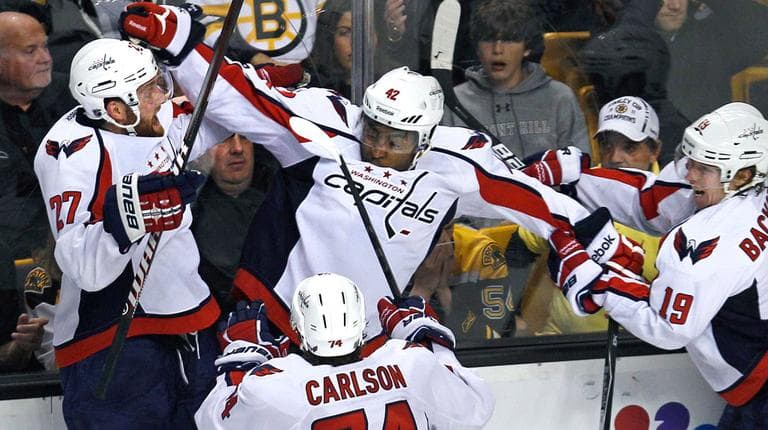 Capitals winger Joel Ward, center, is congratulated by teammates after his Game 7-winning goal against the Bruins Wednesday night. (AP)