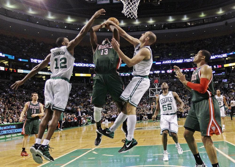 Boston Celtics forward JaJuan Johnson and forward Sasha Pavlovic combine to block Milwaukee Bucks power forward Ekpe Udoh during last night&#039;s game. (AP Photo)