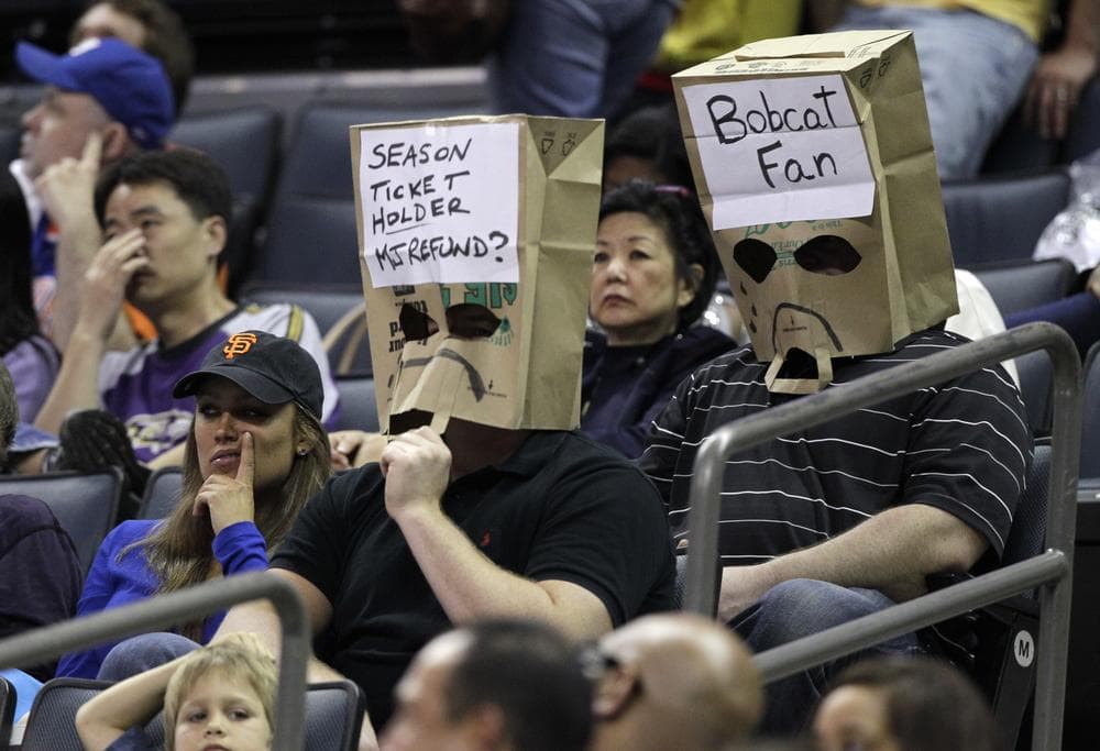 Two Bobcats fans can't bear to watch as Charlotte set an NBA record for futility on Thursday night. The Bobcats finished with the worst winning percentage in NBA history. (AP)