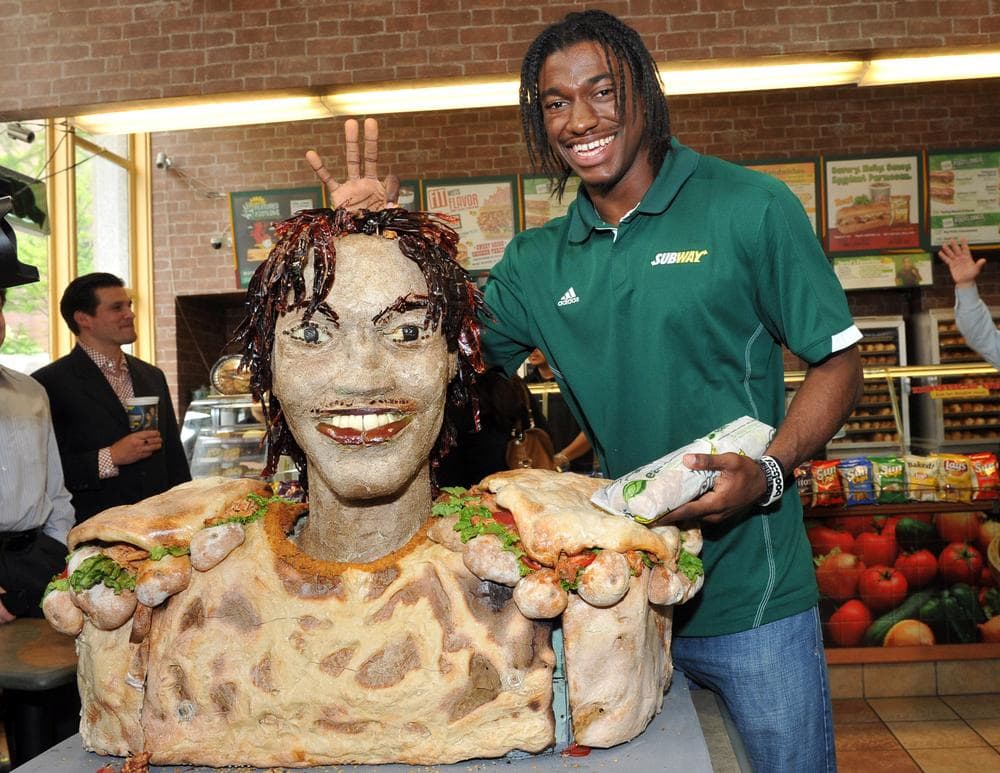 One of the perks of being a top NFL draft pick is getting a life-size replica of your head made out of barbeque chicken. (AP)