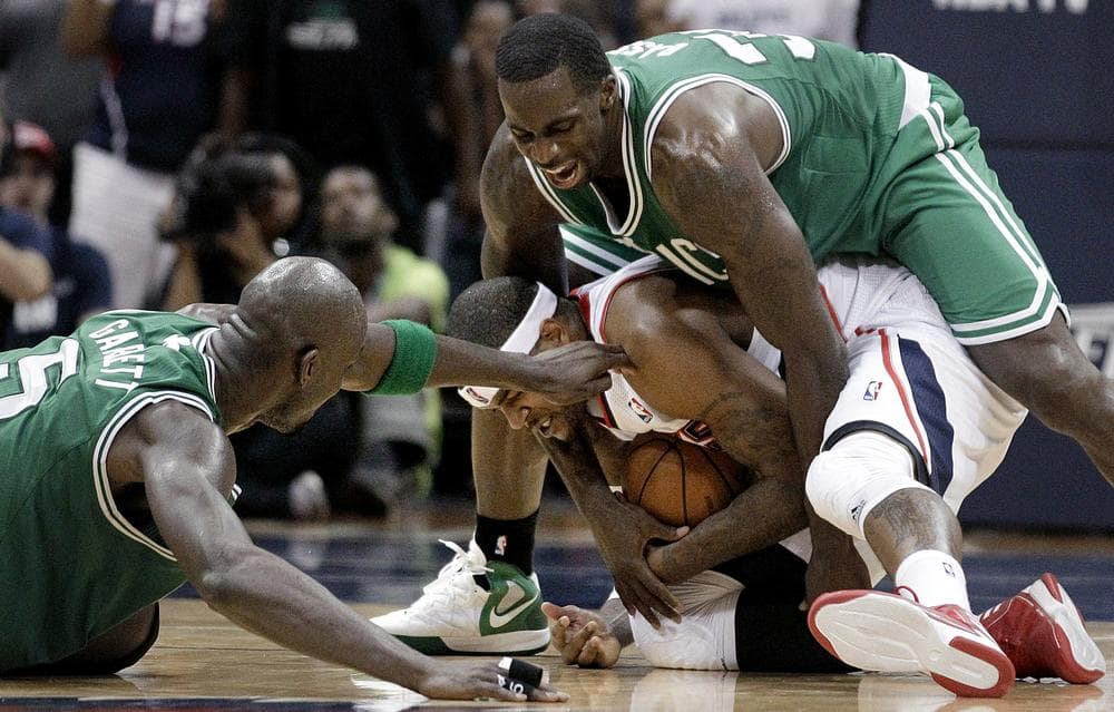 Atlanta Hawks&#039; Josh Smith is fouled by Boston Celtics&#039; Brandon Bass while chasing down a loose ball next to Celtics&#039; Kevin Garnett, left, during the fourth quarter of Game 1 last night. (AP Photo)