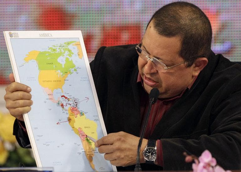 Venezuela's President Hugo Chavez holds a map of the Americas during a session of the Bolivarian Alternative for the Americas, ALBA, trade block at Miraflores presidential palace in Caracas, Venezuela, Sunday, Feb. 5, 2012. (AP)
