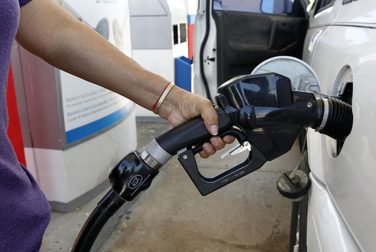 Maria Harris fills her vehicle with gas at a Chevron filling station Monday, March 26, 2012, in Richardson, Texas. (AP)