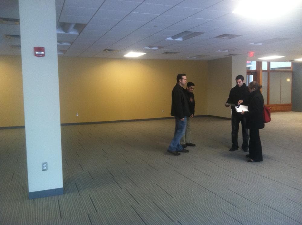 OfficeDrop employees check out &quot;Class A&quot; office space in Kendall Square. (WBUR/Curt Nickisch)