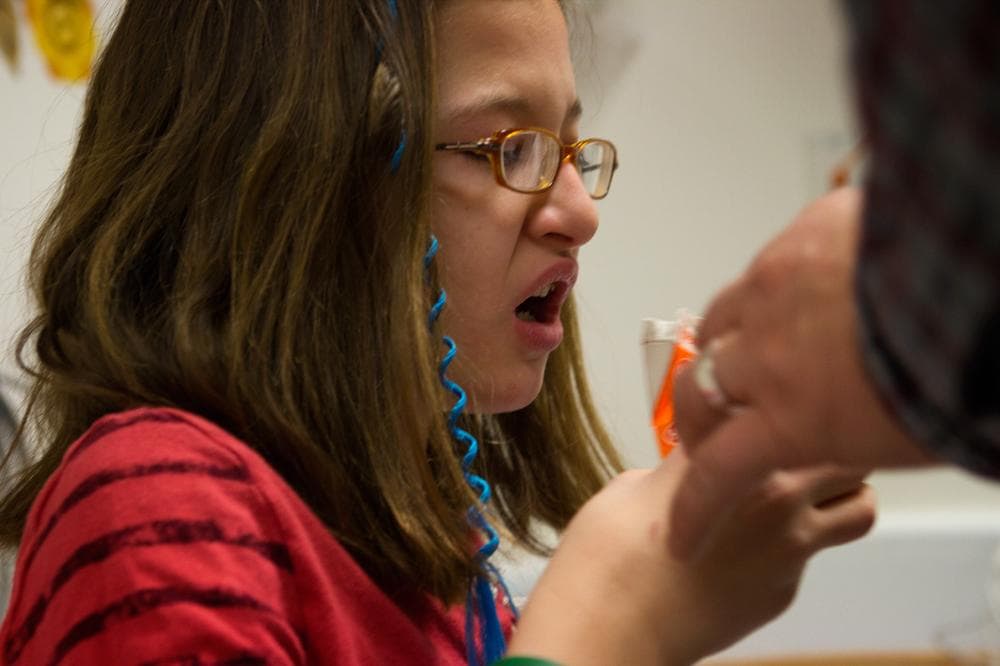 Sirolimus being administered to Riley at a check-up in February 2012 at Children's Hospital Boston. She doesn't like the taste at all, saying, "It tastes like moldy peanut butter." (Jesse Costa/WBUR)