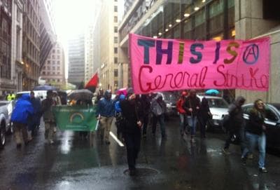 Occupy Boston members march through Boston&#039;s Financial District early Tuesday. (Todd Kazakiewich/WCVB-TV via Twitter)