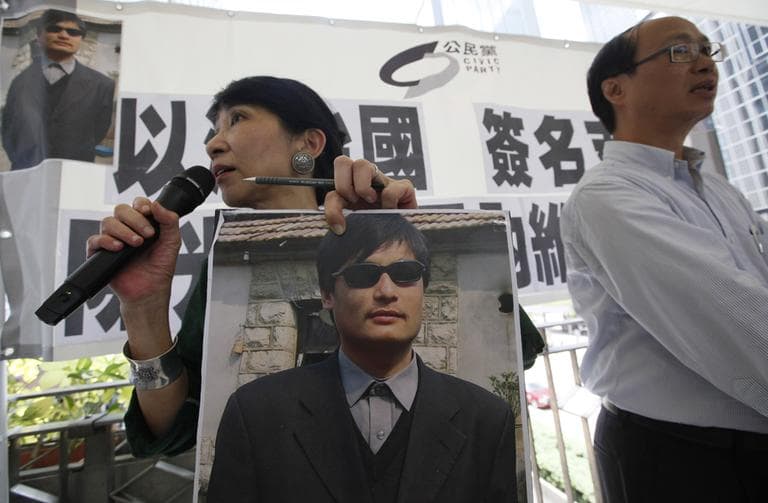 A pro-democracy activist holds a picture of Chen Guangcheng during an event to collect signatures in support of the blind Chinese legal activist, in Hong Kong Wednesday, May 2. (AP)