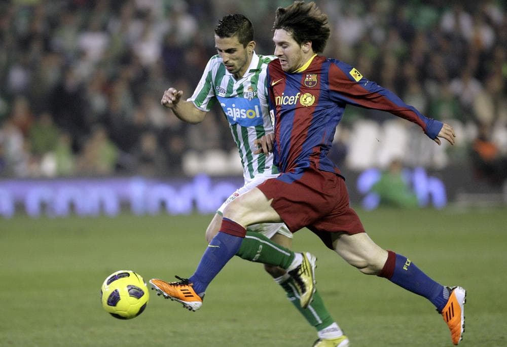 FC Barcelona star Lionel Messi (r), shown here in 2011, broke a European club record when he scored his 68th goal of the season. (AP)