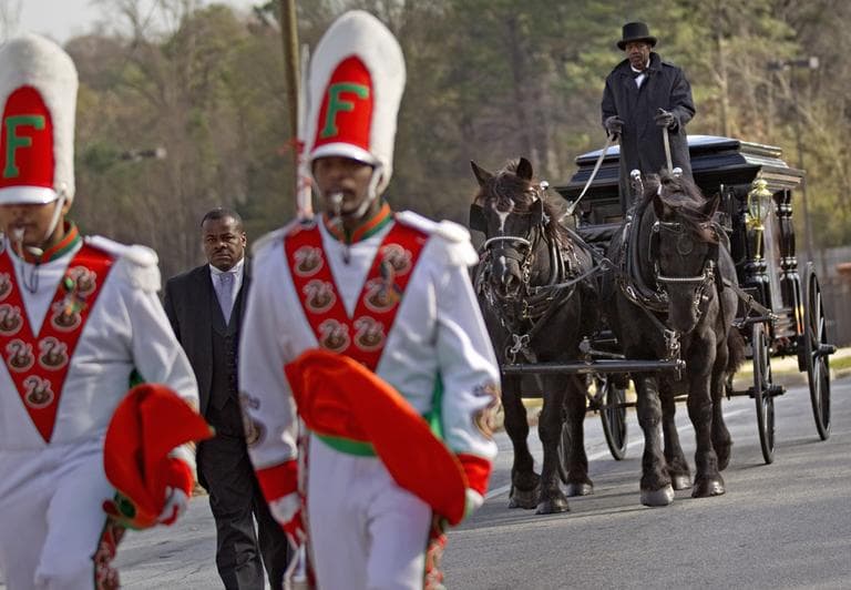 A horse drawn carriage carrying the casket of Florida A&amp;M University band member Robert Champion is lead by his fellow band members following his funeral service Wednesday, Nov. 30, 2011 in Decatur, Ga. The 26-year-old was found dead on Nov. 19 on a bus parked outside an Orlando, Fla. hotel after the school's football team lost to a rival. Authorities suspect hazing but have not released any further details. (AP)
