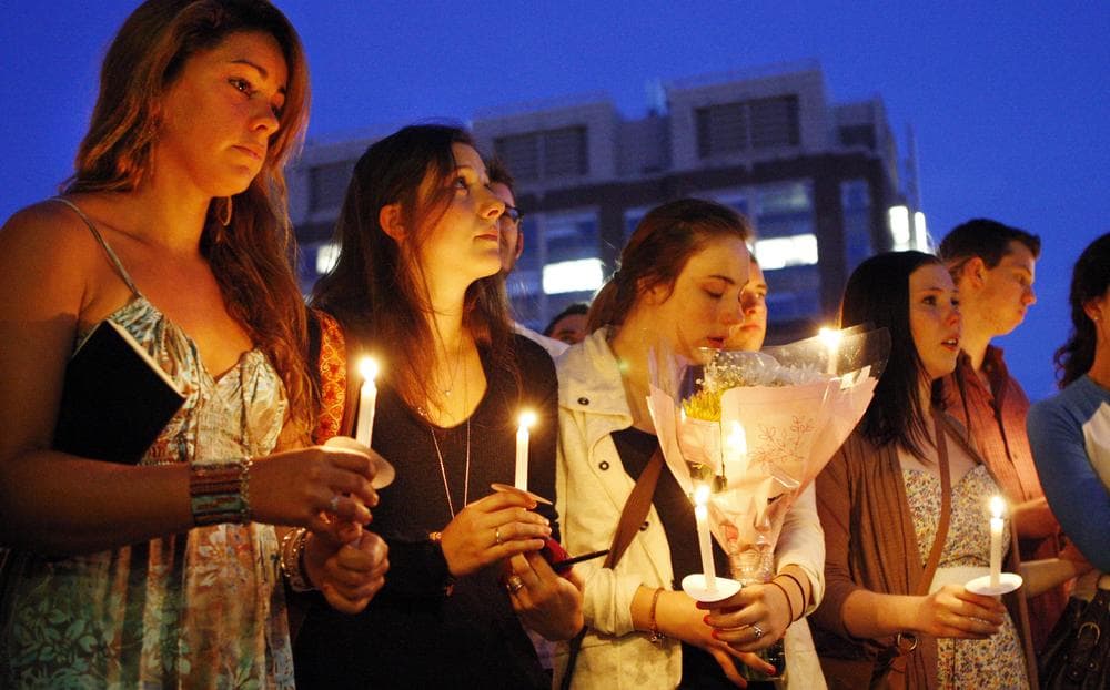 Students including Tori Pinheiro, left, victim Austin Brashears&#039; girlfriend, hold a candlelight vigil on Marsh Plaza at Boston University Saturday night. (AP)