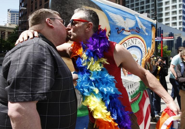 Eric Bennett and Trenton Garris kiss during a demonstration to show support for President Barack Obama. (AP Photo/Kevin P. Casey)