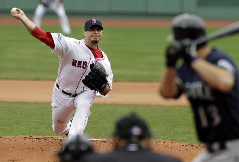 Josh Beckett delivers to Seattle Mariners&#039; Dustin Ackley in the first inning at Fenway Park. Beckett pitched 7 shutout innings, earning the win. (AP)
