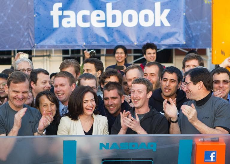 Facebook founder, Chairman and CEO Mark Zuckerberg, center, applauds at the opening bell of the Nasdaq stock market, Friday, from Facebook headquarters in Menlo Park, Calif. (AP/Nasdaq via Facebook, Zef Nikolla)