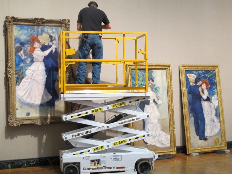 MFA staff preps three Renoir paintings, two on loan from Paris, as a part of its &quot;Visiting Masterpieces&quot; series. All three paintings were created by the artist in the same year.  (Andrea Shea/WBUR) 