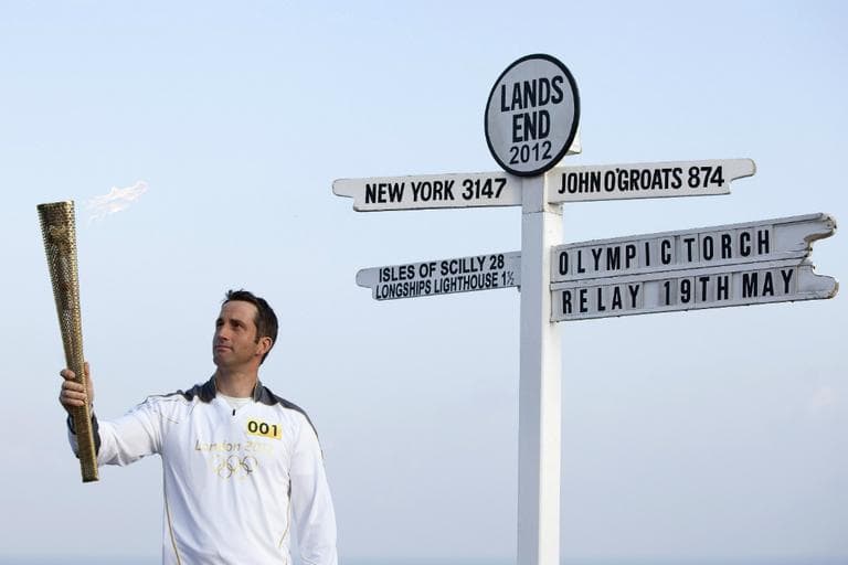 British Olympic sailing hero and three time gold medalist Ben Ainslie holds the Olympic torch at the official start of the London 2012 Olympic games torch relay at Land's End, west of England. (Alastair Grant/AP)