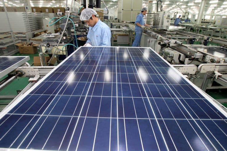 n this photo taken Nov. 18, 2011 and released by China's Xinhua News Agency, Chinese work on the production line at a solar panel factory of the Eoplly New Energy Technology Co., Ltd. in Nantong City, east China's Jiangsu Province. A federal trade panel voted Friday, Dec. 2, 2011 to investigate whether Chinese companies are harming the U.S. solar panel industry by dumping low-price products on global markets. (AP)
