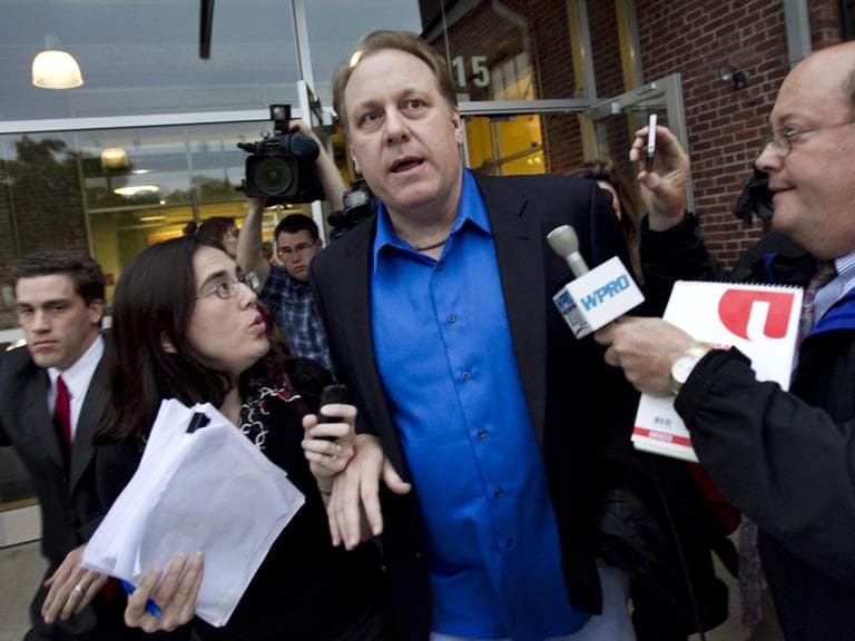 Former Red Sox pitcher Curt Schilling, center, is followed by members of the media as he departs the Rhode Island Economic Development Corporation headquarters in Providence, R.I., Monday, May 21. (AP)