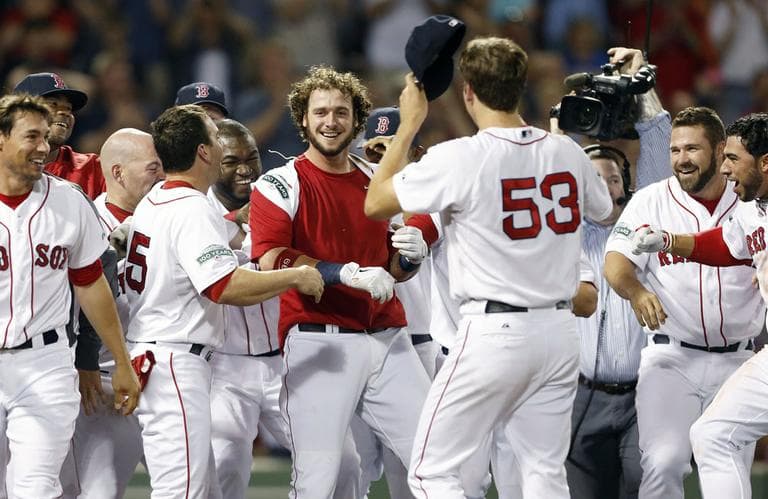 Jarrod Saltalamacchia, center, celebrates with teammates after hitting a two-run home run to defeat the Tampa Bay Rays 3-2 in the ninth inning of a baseball on Saturday. (AP Photo/Michael Dwyer)
