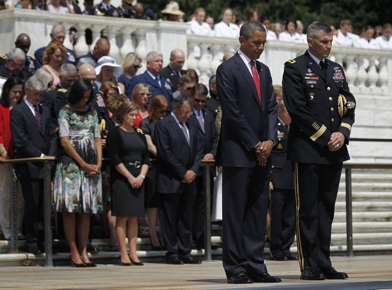 President Barack Obama, and Maj. Gen. Michael S. Linnington, Commander of the U.S. Army Military District of Washington, lowers their heads during a wreath-laying ceremony at the Tomb of the Unknowns at Arlington National Cemetery on Memorial Day, Monday, May 28. (AP)