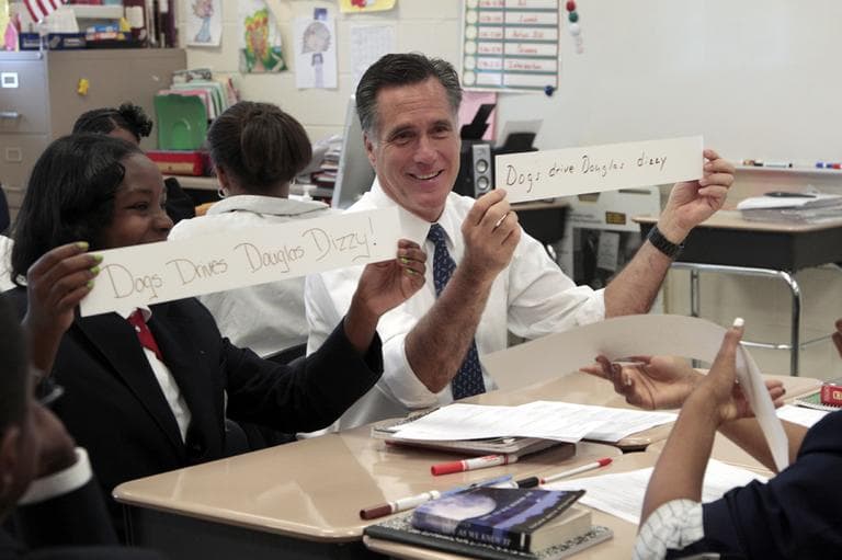 Republican presidential candidate, former Massachusetts Gov. Mitt Romney, and Salina Beattie display class work they did together in the 6th grade language arts class during Romney's tour of the Universal Bluford Charter School, Thursday, May 24, 2012, in Philadelphia. (AP)