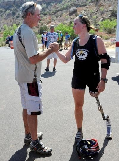 Former President George W. Bush shakes hands with retired U.S. Army 1st Lt. Melissa Stockwell at the end of the Bush Center Warrior 100K Race at Palo Duro Canyon State Park in Amarillo, Texas. (AP)