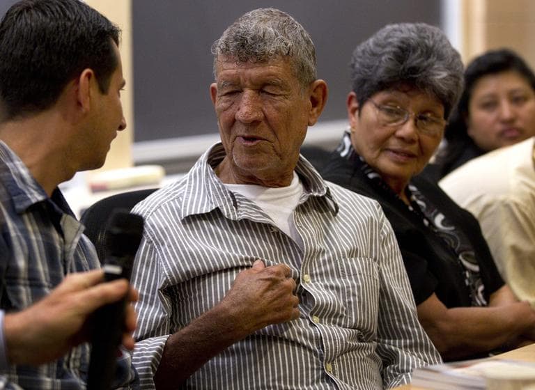 Survivor of the Dos Erres massacre Oscar Ramirez, left, speaks with his father Tranquilino Castaneda, center, as human right activist Elena Farfan, right, looks on during during a panel discussion on the 1982 Dos Erres massacre in Guatemala at Harvard University, Wednesday, May 30. (AP)