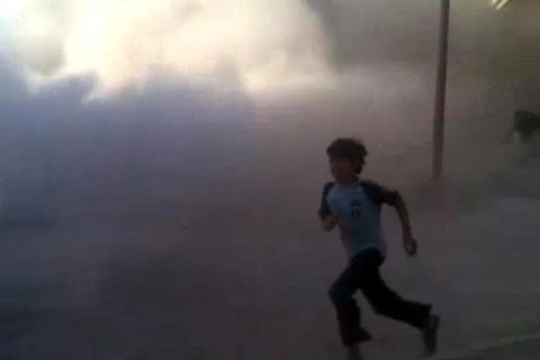 This frame grab made from an amateur video provided by Syrian activists on Monday, May 28, 2012, purports to show the massacre in Houla on May 25 that killed more than 100 people, many of them children. The amateur footage shows people running along a street, purportedly just after the attack on Houla started. (AP)