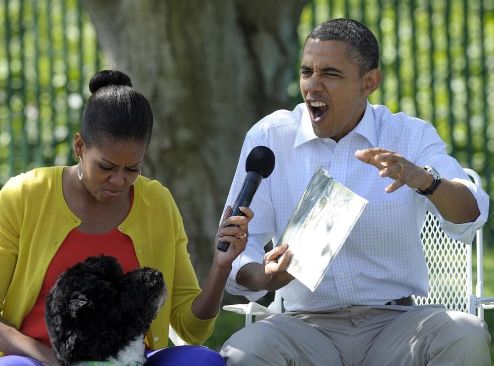 President Barack Obama, accompanied by first lady Michelle Obama, and first dog Bo, reads &quot;Where the Wild things Are&quot; during the annual White House Easter Egg Roll, Monday, April 9, 2012, on the South Lawn of the White House in Washington. Author Maurice Sendak died this week. (AP)