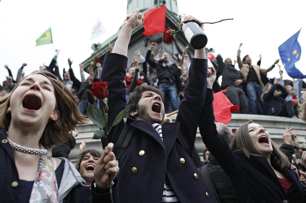 Supporters of Socialist Party candidate Francois Hollande react after the first results of the second round of French presidential elections were announced at Bastille Square in Paris, France, Sunday, May 6. (AP)