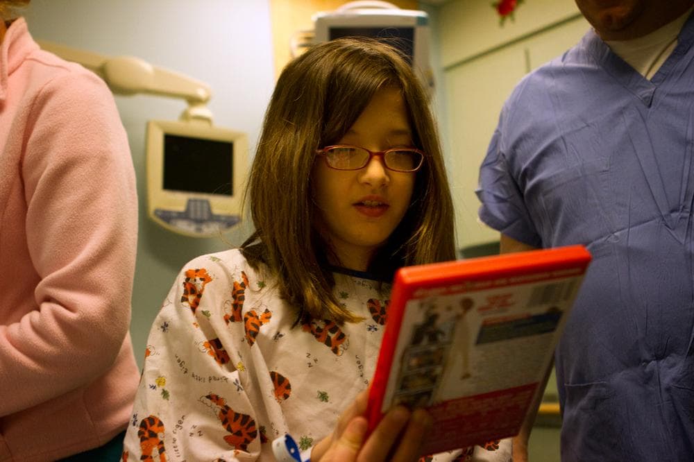 Riley chooses a movie to watch for her 2 1/2 hours MRI scan at Children&#039;s Hospital Waltham, MA. (Jesse Costa/WBUR)