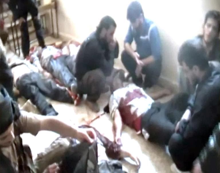 This image made from amateur video released by Shaam News Network and accessed Friday, June 1, 2012, purports to show the bodies of Syrian workers who were killed near Qusair, in Homs province, Syria. Gunmen killed several workers at a state-owned fertilizer factory in a volatile central Syrian province, activists said Friday, the second execution-style shooting reported in Syria in less than a week. The shooting near the town of Qusair in Homs province occurred Thursday as the workers were on their way to their jobs in a bus that came under fire, said the Britain-based Syrian Observatory for Human Rights. (AP)