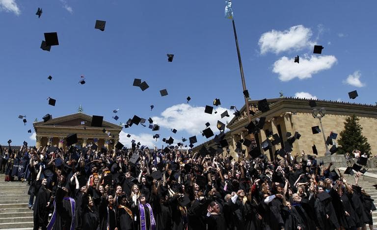 Over 300 graduating students from 19 area colleges and universities throw their mortarboards in the air on the steps of the Philadelphia Museum of Art in a ceremony to honor their accomplishments sponsored by Philadelphia Mayor Michael Nutter Friday, May 11, 2012 in Philadelphia. (AP Photo/Alex Brandon)