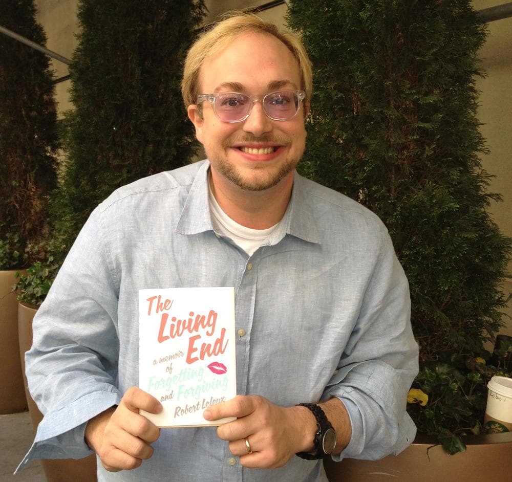 Author Robert Leleux, holding his book "The Living End: A Memoir of Forgetting and Forgiving." (Robin Young/Here & Now)