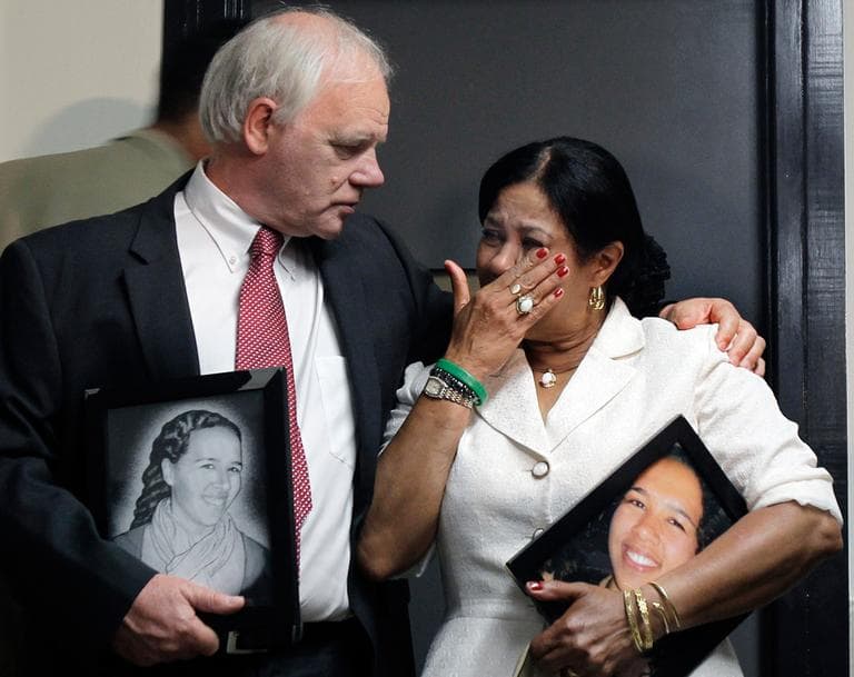 Nicholas and Virginia Payne hold pictures of their slain daughter, Rebecca, outside a Boston courtroom Monday. (AP)