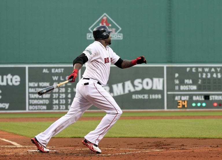 David Ortiz follows through on a two-run homer against the Miami Marlins in the first inning of a baseball game at Fenway Park in Boston on Tuesday. (AP/Elise Amendola)