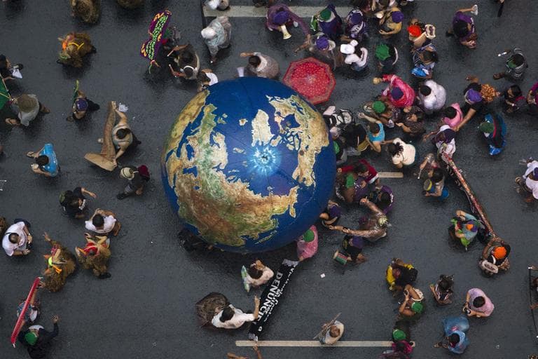 Activists push an inflatable globe during a &quot;Global March&quot; as part of the People's Summit for Social and Environmental Justice in Defense of the Commons, a parallel event during the UN Conference on Sustainable Development, or Rio+20, in Rio de Janeiro, Brazil, Wednesday, June 20, 2012. (AP)