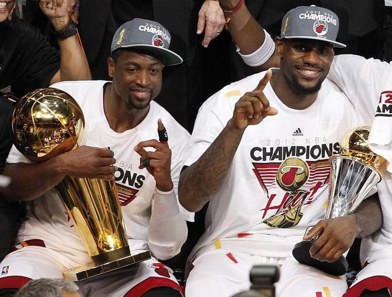 The Miami Heat&#039;s Dwyane Wade holds the the Larry O&#039;Brien NBA Championship Trophy and LeBron James holds his most valuable player trophy after Game 5 of the NBA finals. (AP)