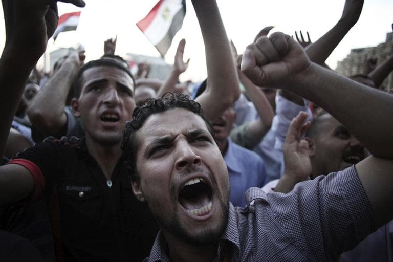 Egyptian men chant anti-Supreme Council for the Armed Forces (SCAF) slogans in Tahrir Square in Cairo, Egypt, Thursday. (AP)