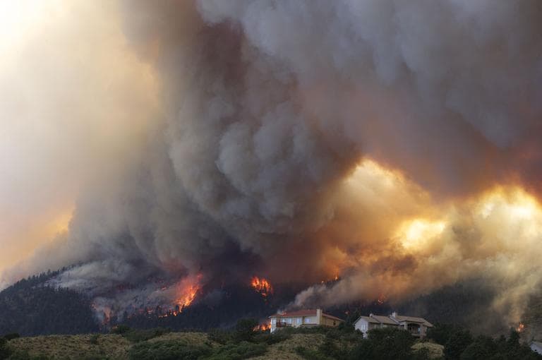 Fire from the Waldo Canyon wildfire burns as it moved into subdivisions and destroyed homes in Colorado Springs, Colo., on Tuesday. (AP)