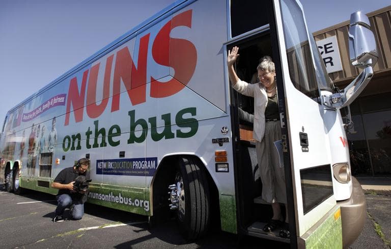 Sister Simone Campbell, executive director of Network, waves as she steps off the bus during a stop on the first day of a 9-state Nuns on the Bus tour, in Ames, Iowa. (AP)