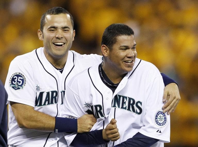 Seattle Mariners pitcher Felix Hernandez, right, is embraces by Jesus Montero after the team beat the Boston Red Sox on Thursday. (AP Photo/Elaine Thompson)