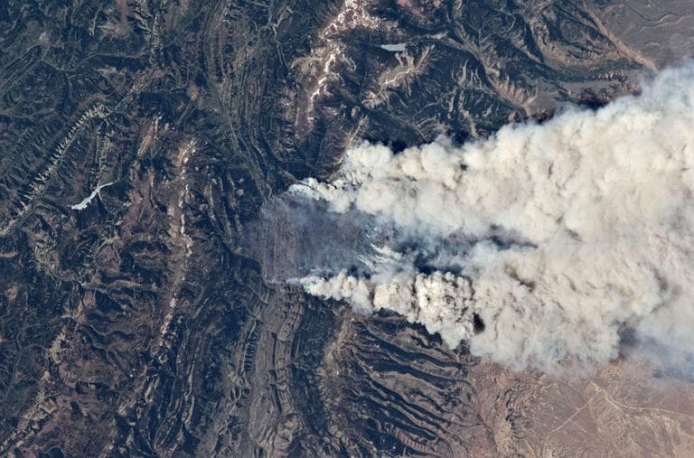 In this Wednesday June 27,2012 photo released by NASA showing wild fires burning at the south end of the Wyoming Range in southwestern Wyoming taken aboard the International Space Station, 240 miles above earth. These particular fires, of unknown cause, are burning at the south end of the Wyoming Range in southwestern Wyoming, and have affected 17,000 acres. (AP)