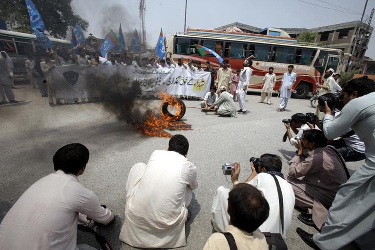 Pakistani students of Jamaat-i-Islami burn tire and rally to condemn the resumption of NATO supplies to neighboring Afghanistan through Pakistan, in Peshawar, Pakistan, Thursday, July 5. (AP)