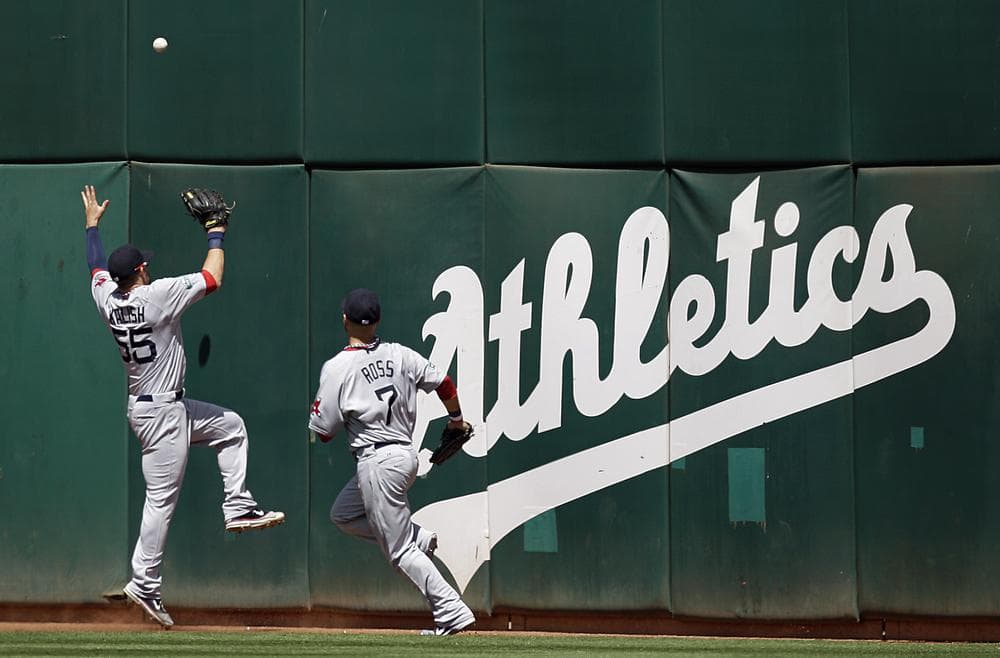 Red Sox outfielders Ryan Kalish, left, and Cody Ross fail to make the catch on a ball that fell for a triple hit by Oakland Athletics' Coco Crisp in the seventh inning of last night's game in Oakland. (AP Photo)