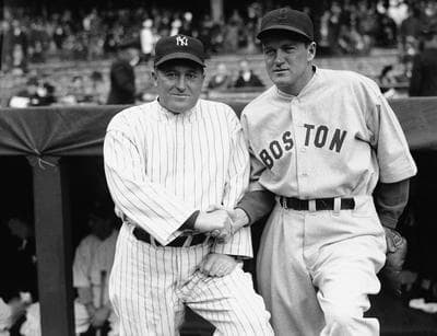 Joe McCarthy, left, manager of the New York Yankees, and Joe Cronin, right, big chief of the Boston Red Sox, are shown just before their teams met, April 16, 1935 in Yankee Stadium, New York, before a crowd of 40,000. (AP Photo)