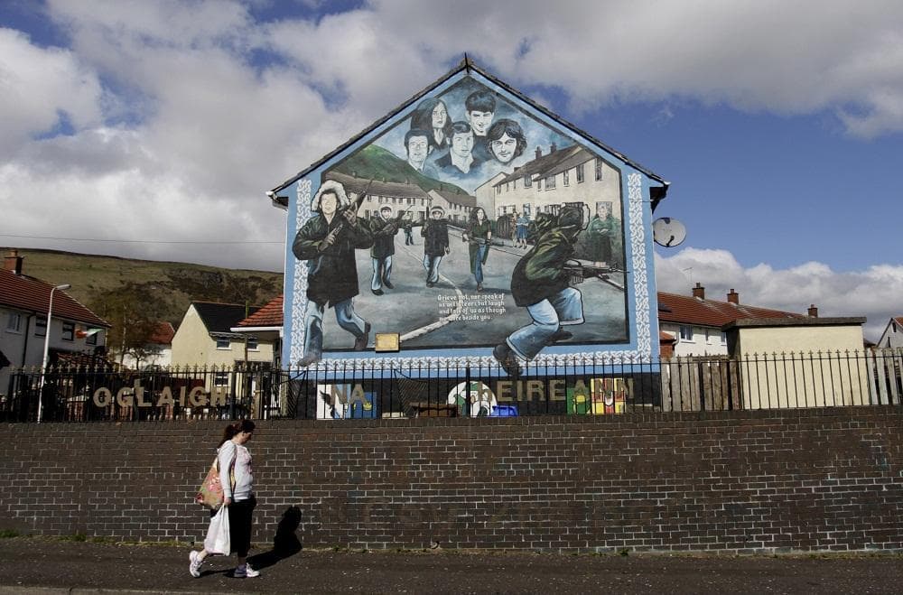 A woman walks past an Irish Republican Army mural in West Belfast, Northern Ireland, Wednesday, April, 4, 2012.  A U.S. appeals court ruled that interviews given by former IRA members must be handed over to the Police Service of Northern Ireland.  The interviews are part of the Boston College Belfast Project which began in 2001 and lasted five years. (AP)