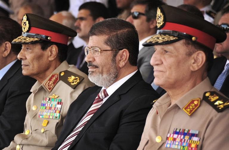 Egyptian Field Marshal Gen. Hussein Tantawi, left, and new President Mohammed Morsi, center, attend a medal ceremony, at a military base east of Cairo, Egypt. (AP/Mohammed Abd El Moaty, Egyptian Presidency)