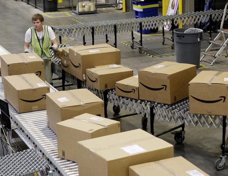 A worker separates packages for final shipment inside the 800,000 sq. ft. Amazon.com warehouse in Goodyear, Ariz. (AP)