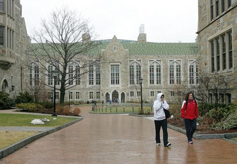 Boston College students walk across the college campus (AP)