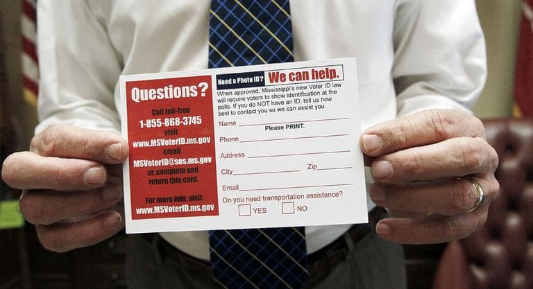 Mississippi Secretary of State Delbert Hosemann holds a postcard to help identify voters in need of a free state government issued card that is issued through his office at no charge, in Jackson, Miss. (AP)